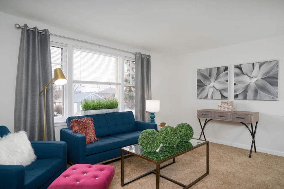 a living room with a blue couch and a coffee table