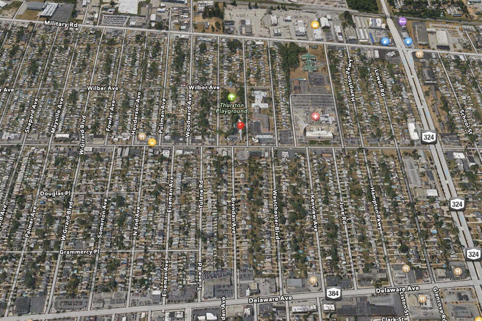 an aerial view of a city with many houses and trees