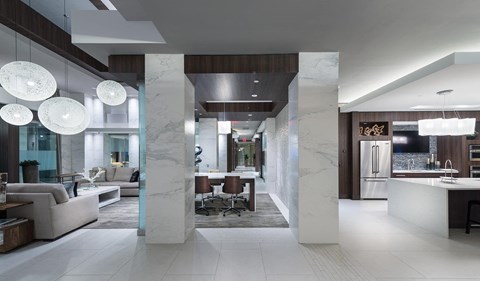 A modern living room with a white marble floor and a kitchen area with a sink and refrigerator.