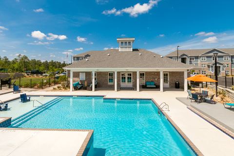 the pool and clubhouse at the estates apartments