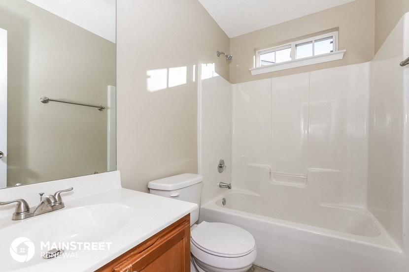 a bathroom with a shower toilet and sink and a mirror