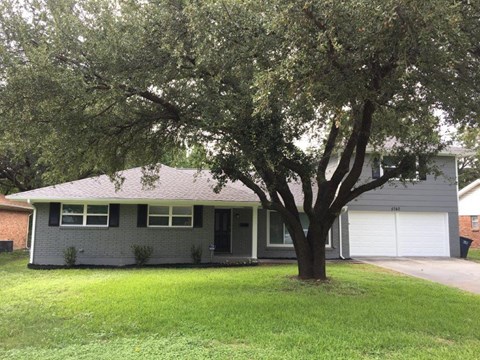 a house with a large tree in front of it
