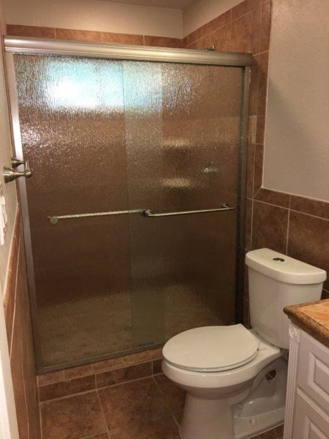 a bathroom with a toilet and a shower