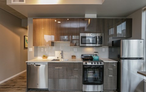 a kitchen with stainless steel appliances and wooden cabinets