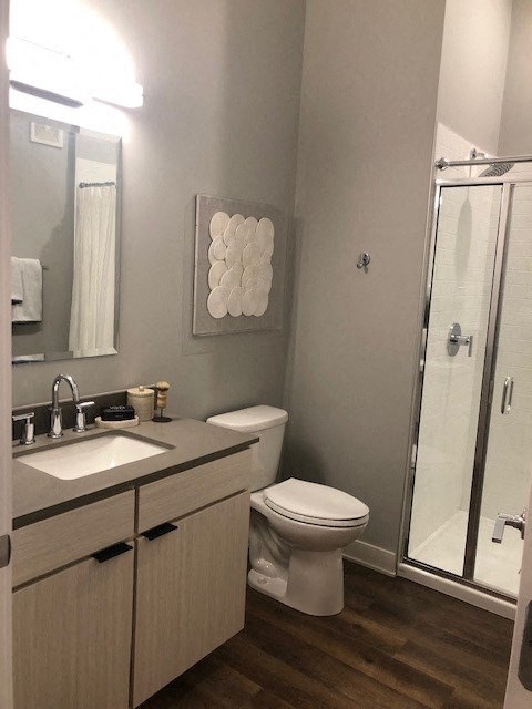 a bathroom with a toilet and a sink and a shower