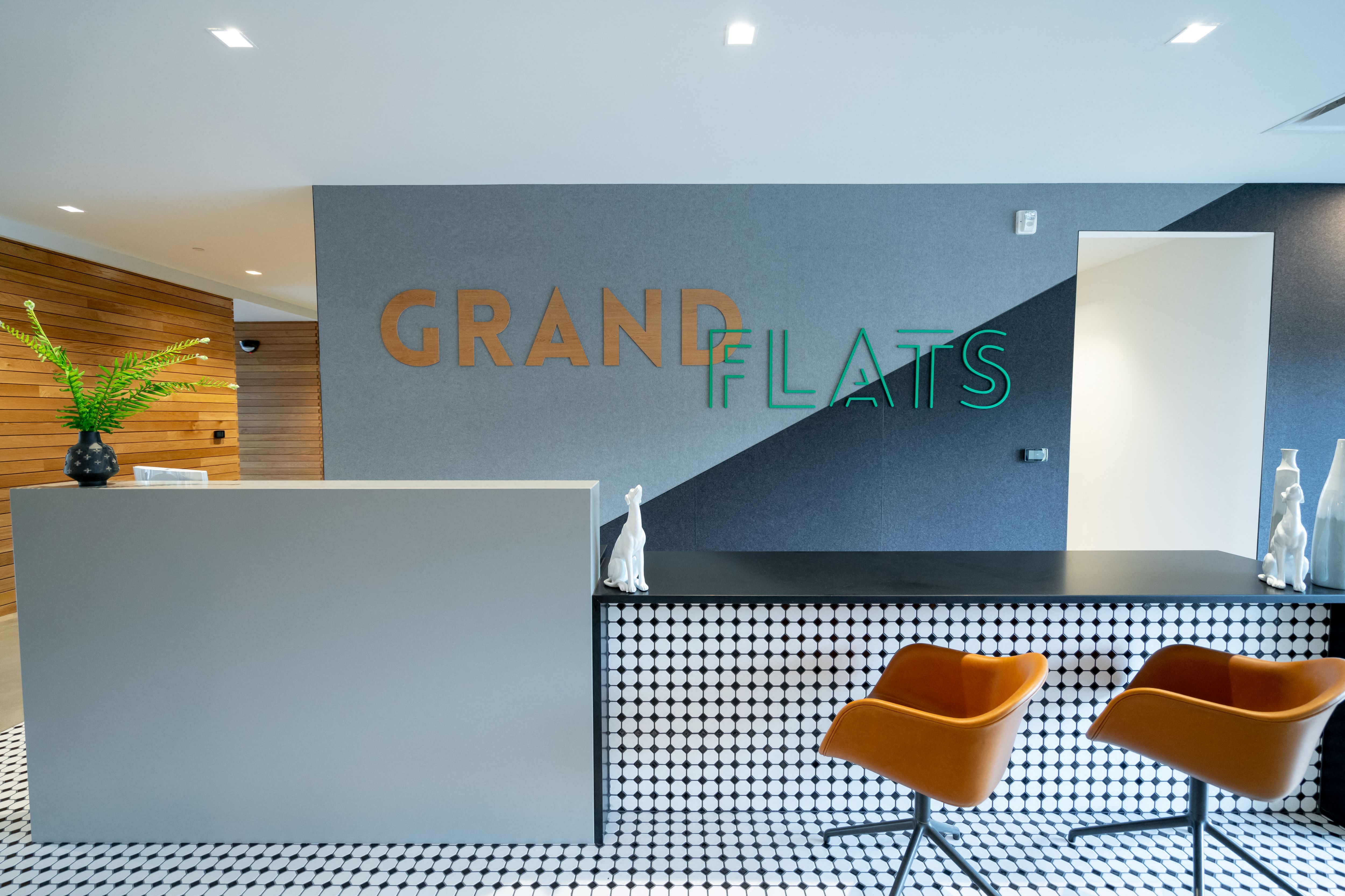 a lobby with a reception desk and two chairs