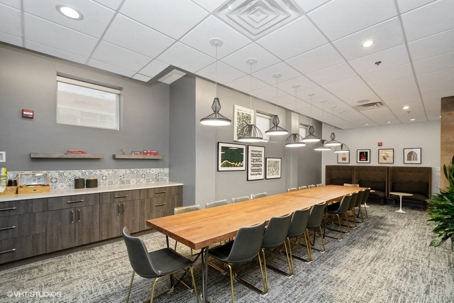 a conference room with a long table and chairs