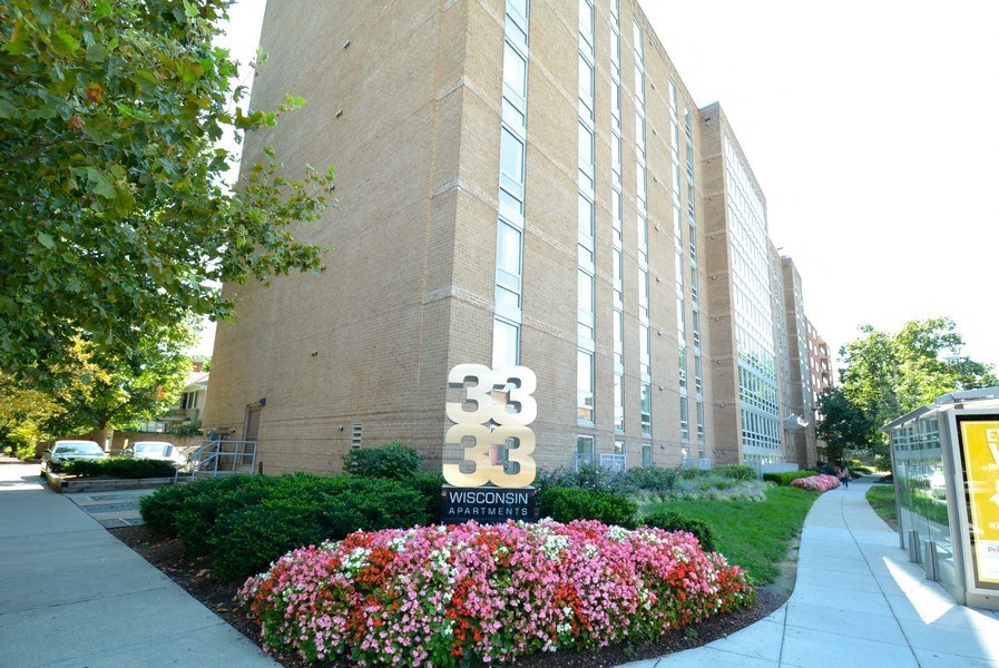 a large brick building with a sign in front of it