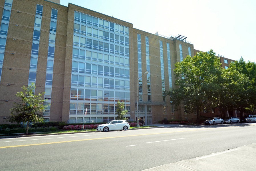 a car parked in front of a large brick building