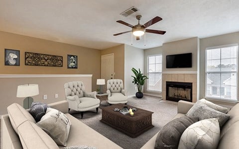 a living room with a couch and chairs and a ceiling fan
