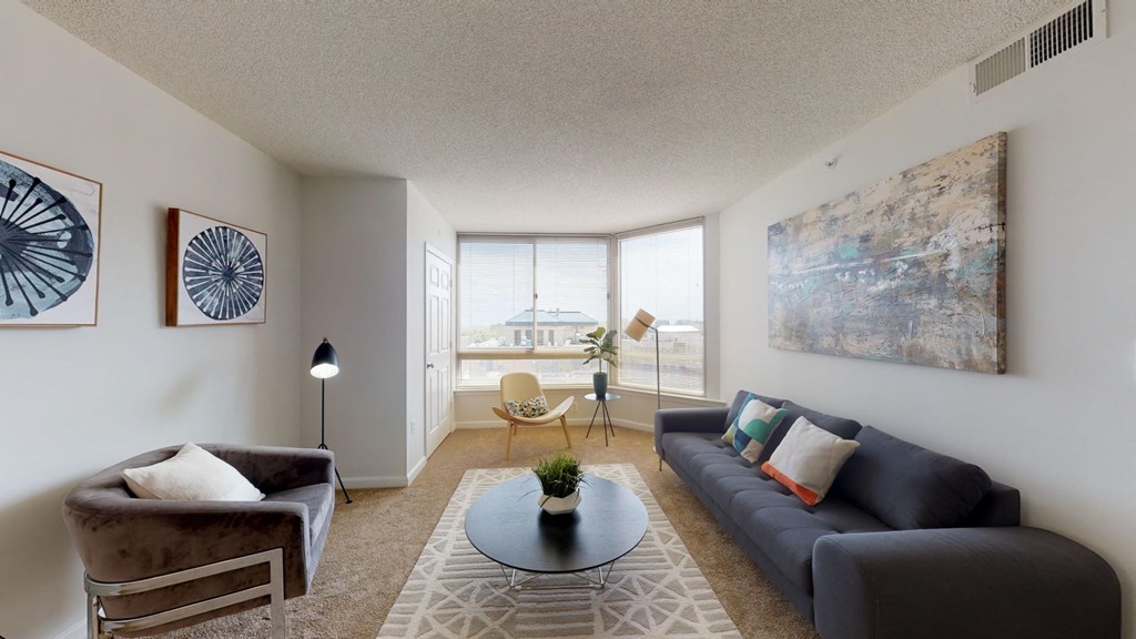 a living room with a couch and a table and a window