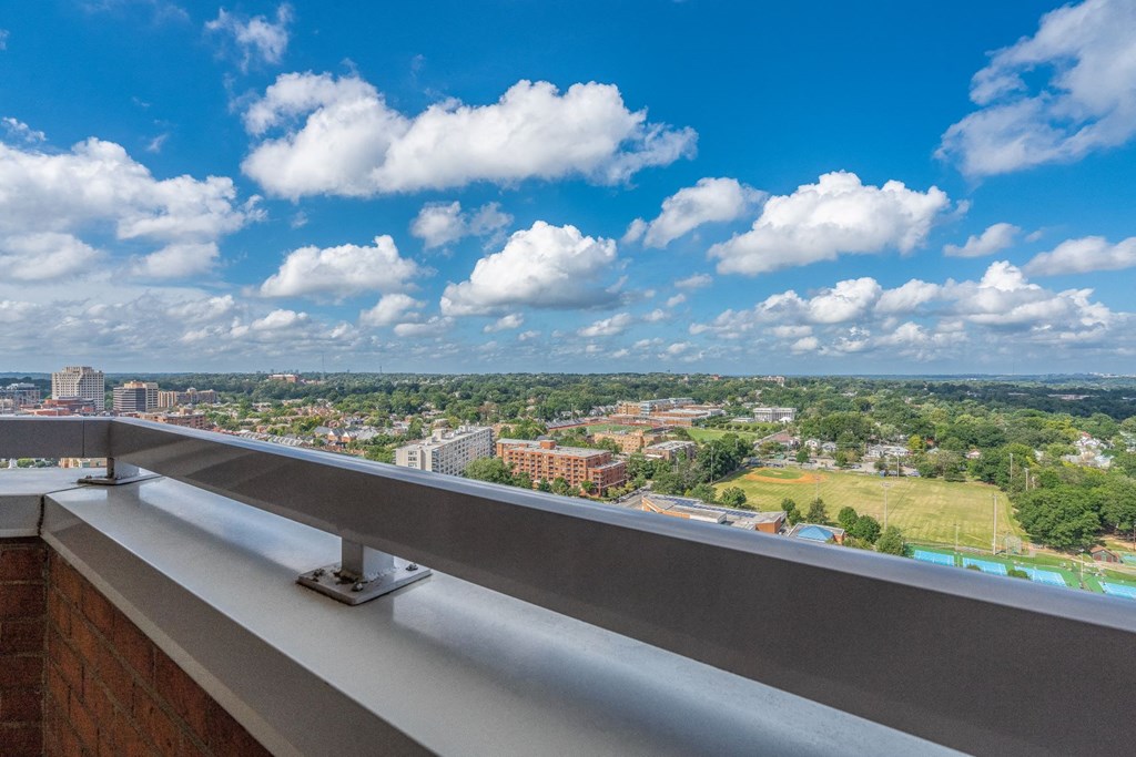a view of the city from a balcony on a skyscraper