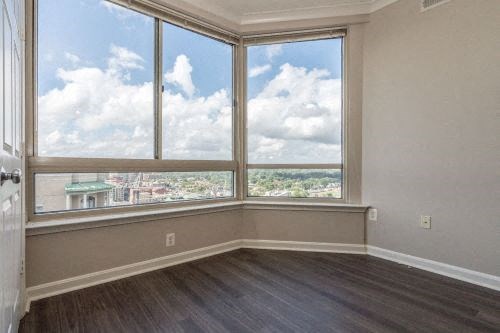 an empty living room with a large window