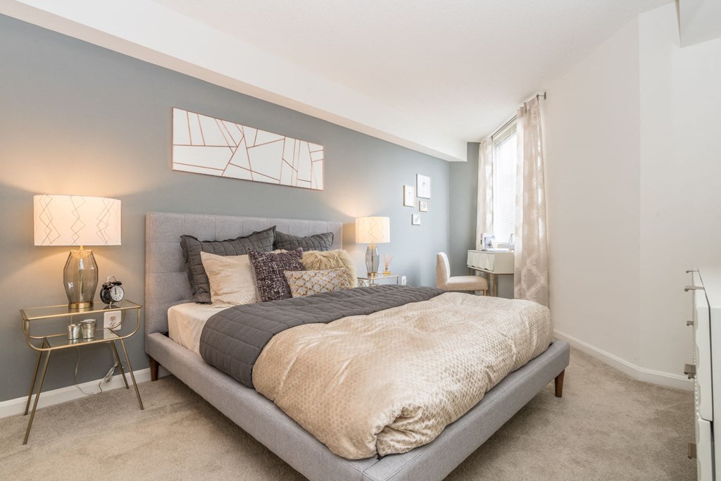 a bedroom with a bed and a window