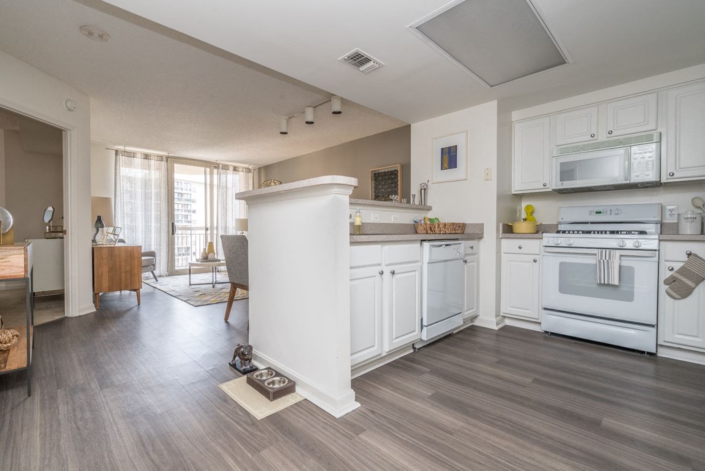 a kitchen with white cabinets and a white stove top oven