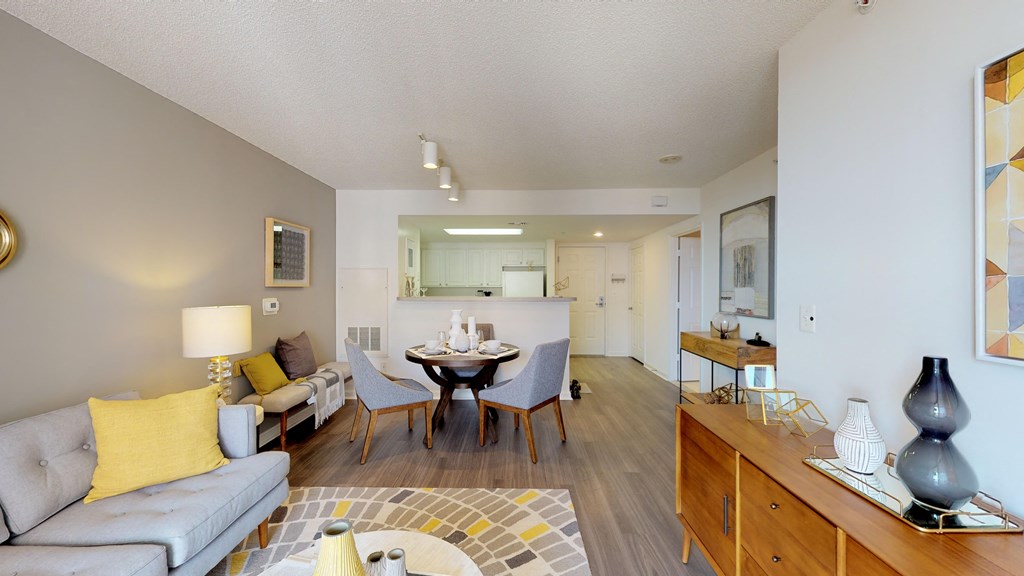 a living room and dining room with a table and chairs