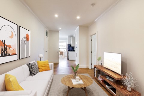 A living room with a white couch and a wooden coffee table.