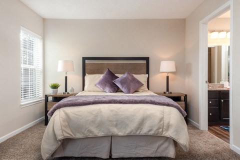 a bedroom with a large bed and a mirror
