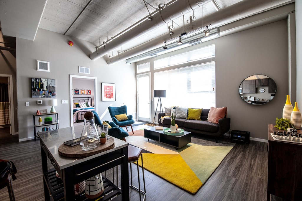 a living room with a couch and a table and a large window