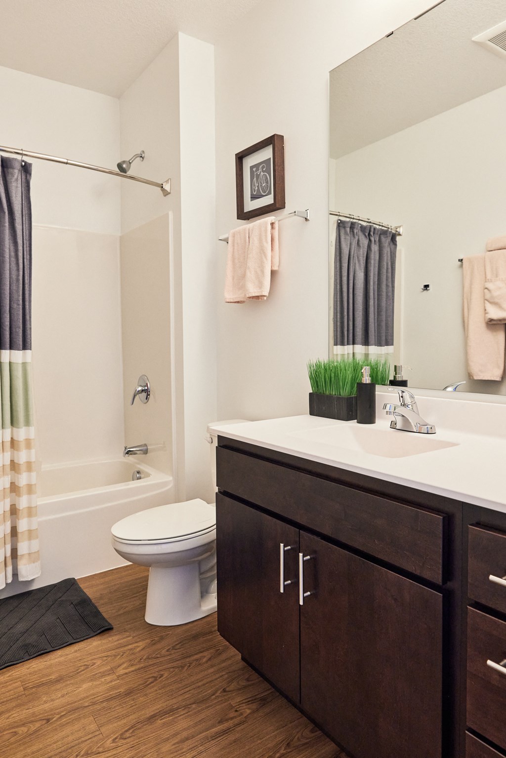 a bathroom with a sink toilet and shower and a mirror