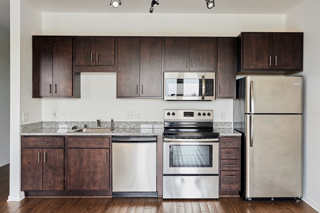 a kitchen with stainless steel appliances and wooden cabinets