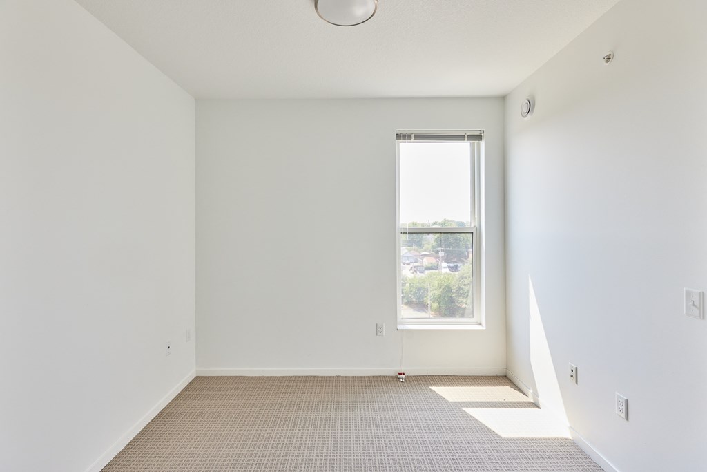 a room with white walls and a window