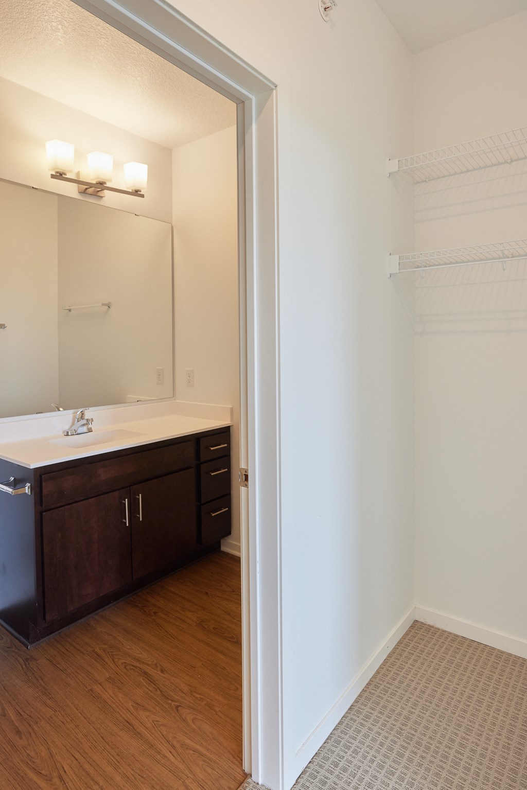 an empty bathroom with a sink and a mirror