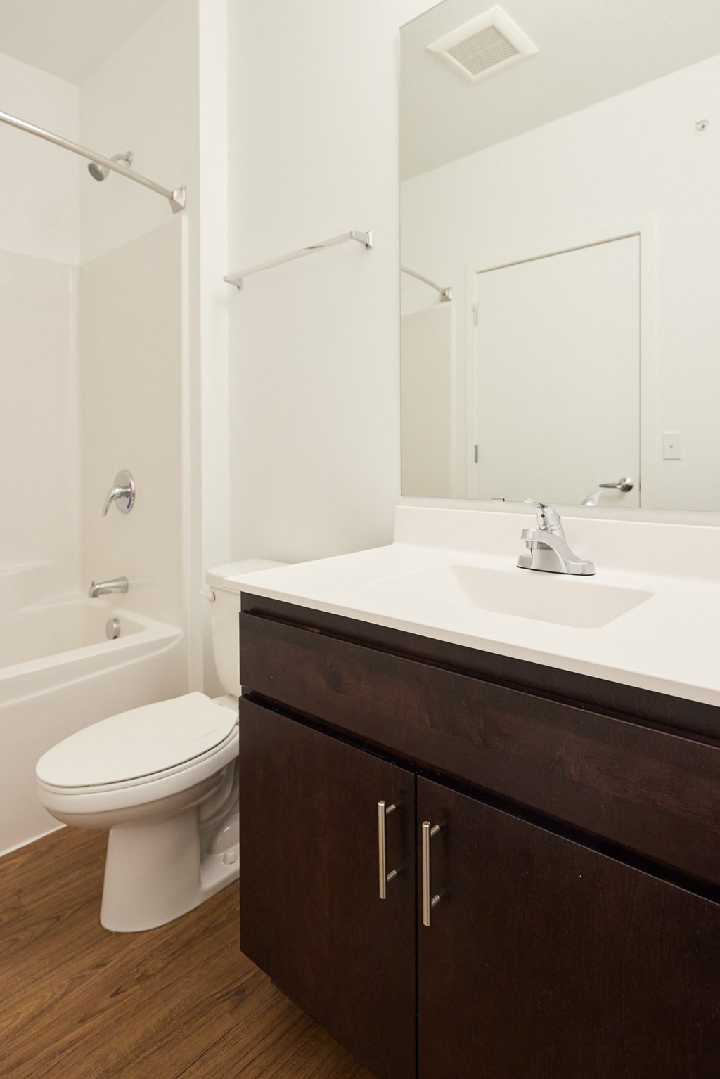 a bathroom with a toilet and a sink and a mirror