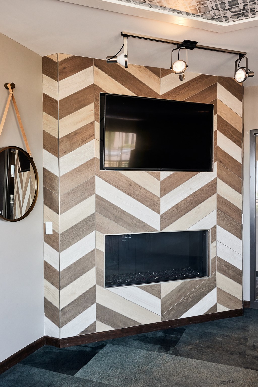 a living room with a fireplace and a tv on the wall