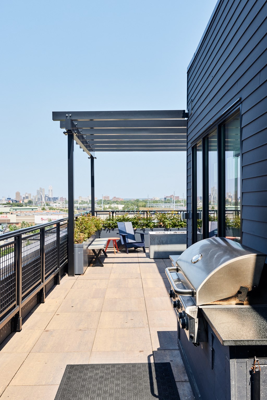 a patio with a grill and a view of the city