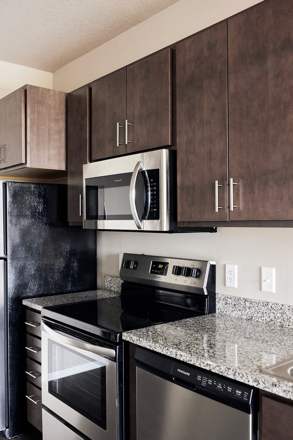 an updated kitchen with stainless steel appliances and granite counter tops