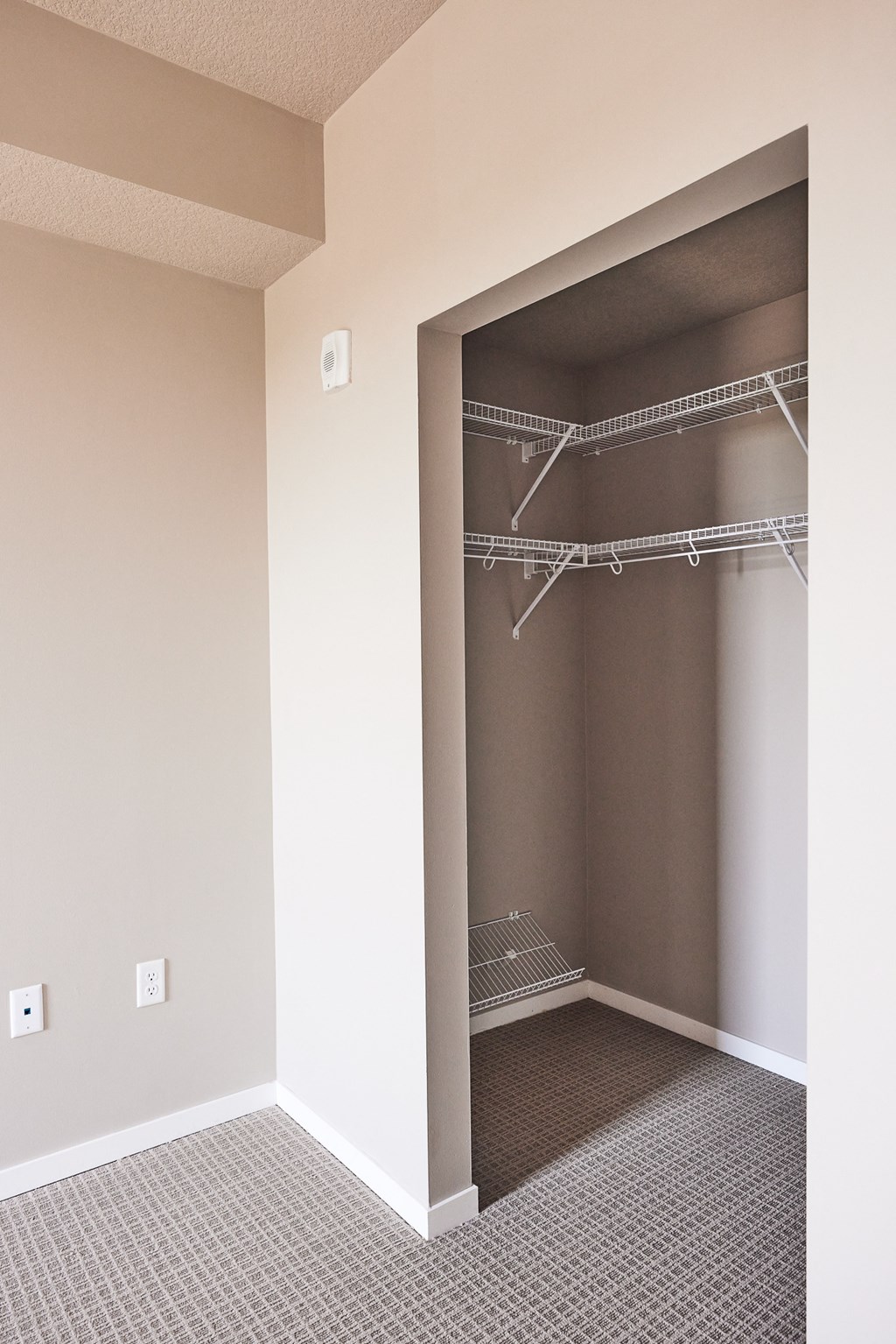 an empty closet in a home with a mirrored closet door