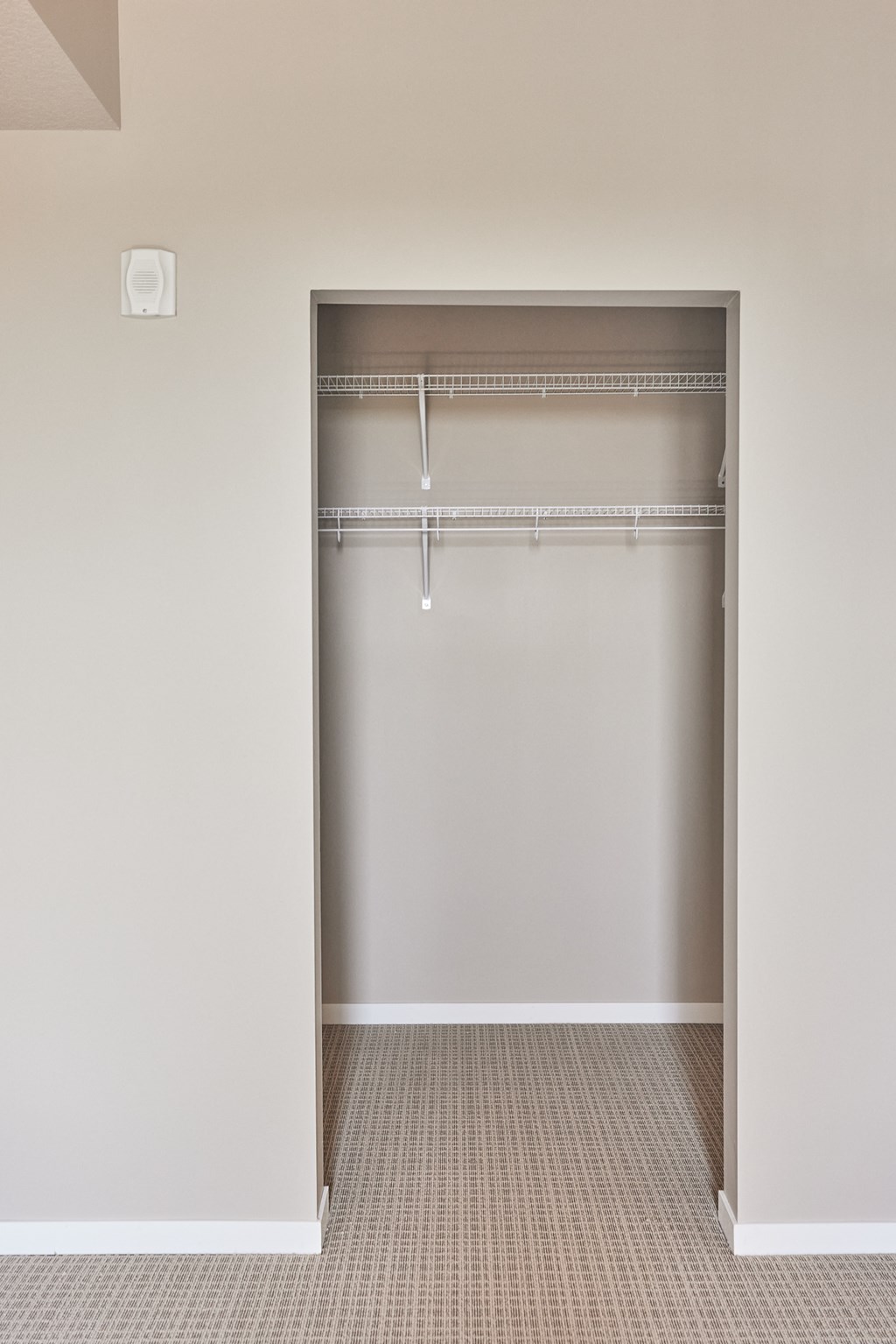 an empty closet in an empty room with a door open