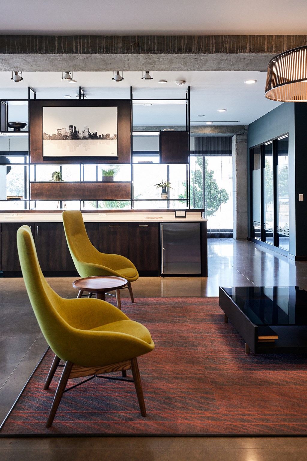a modern living room with yellow chairs and a kitchen