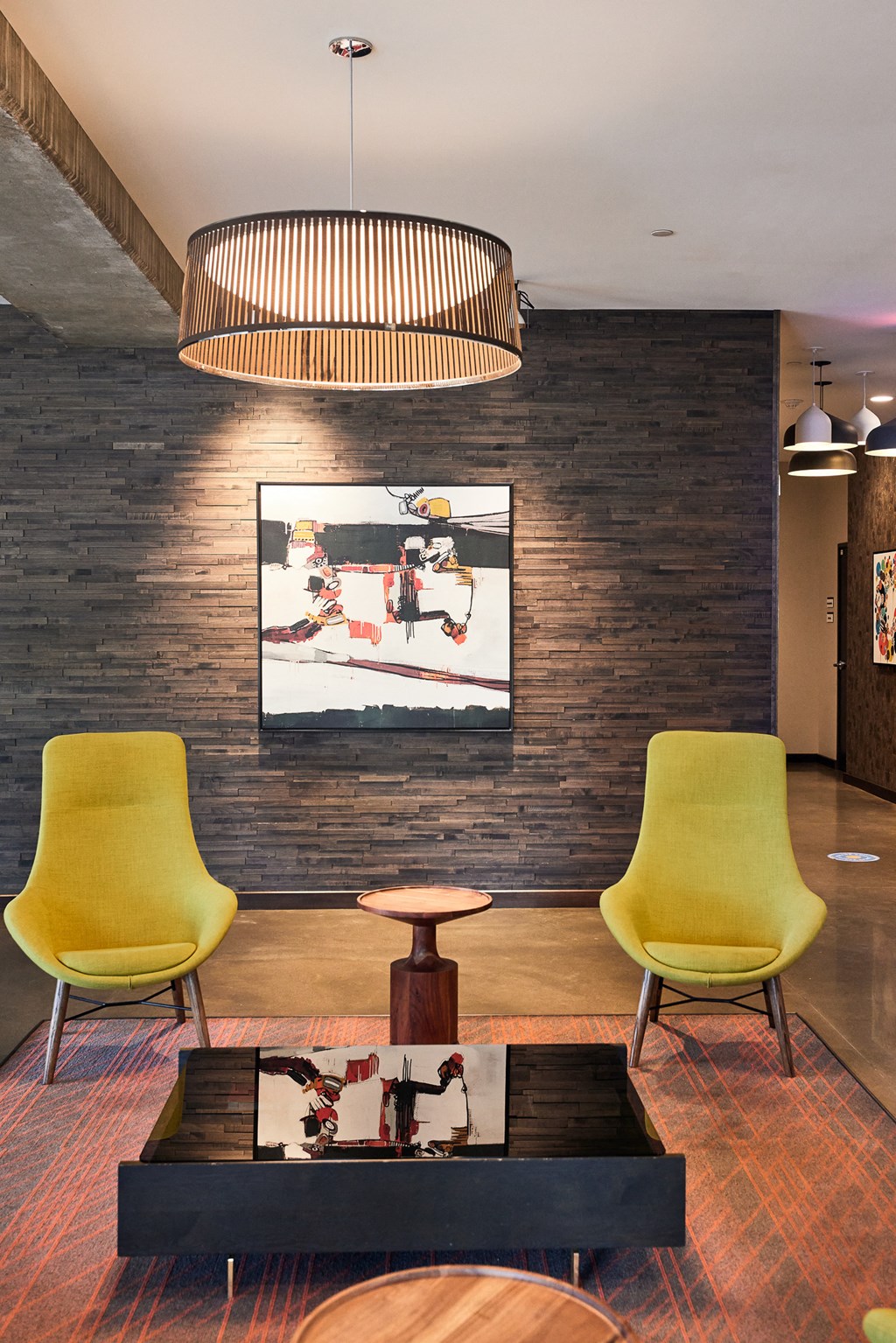 a living room with yellow chairs and a black coffee table