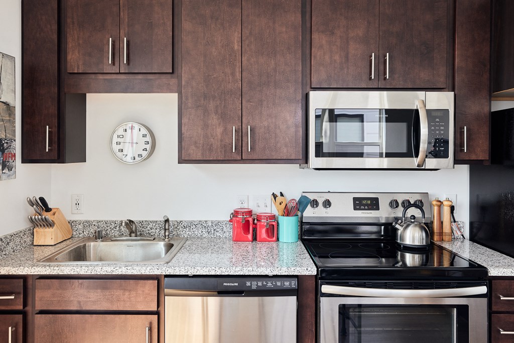 a kitchen with stainless steel appliances and wooden cabinets