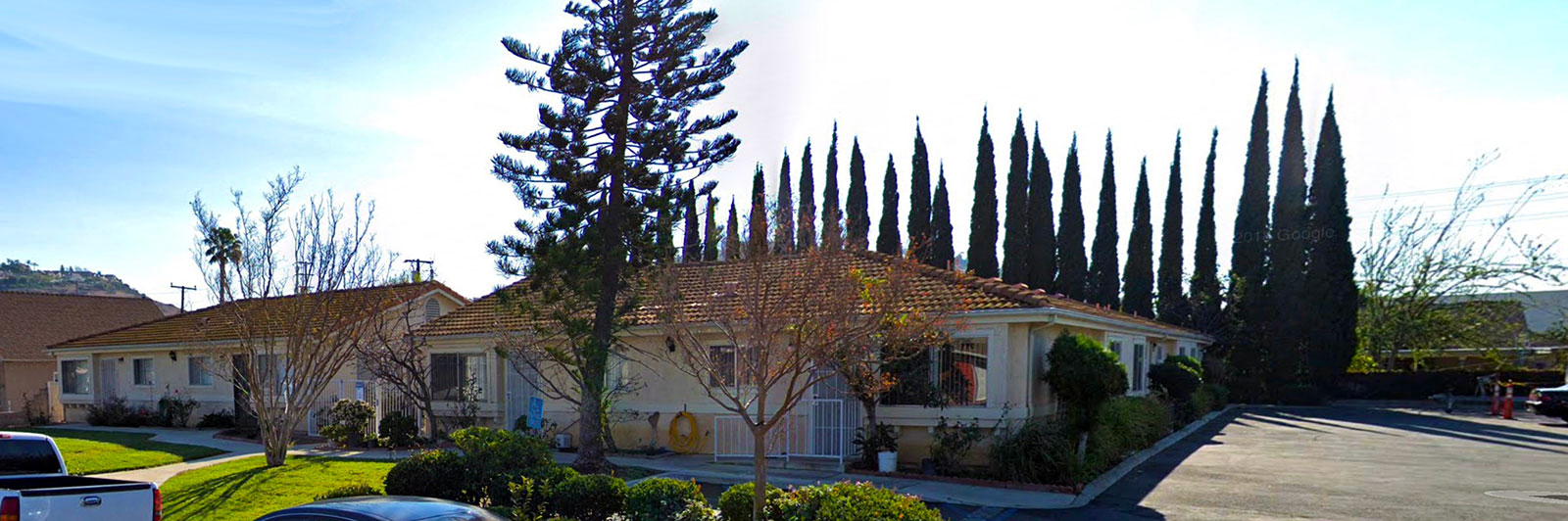 a house with tall trees in front of it