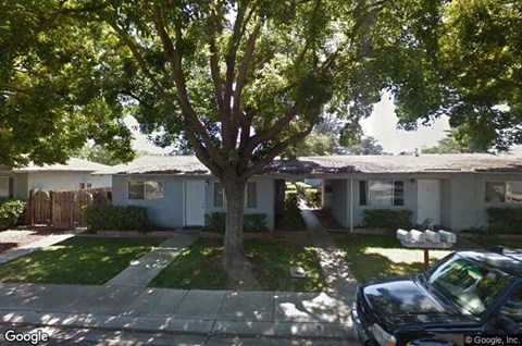 a house with a tree in the front of it