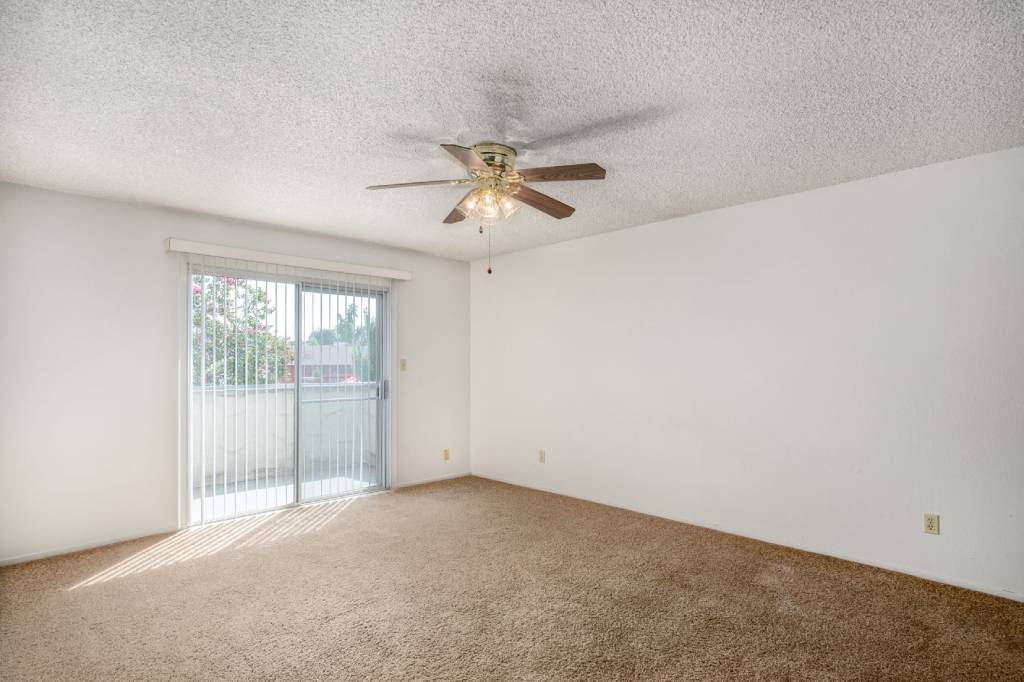 Spacious Living Area With Balcony at Barcelona Apartments, Visalia, CA