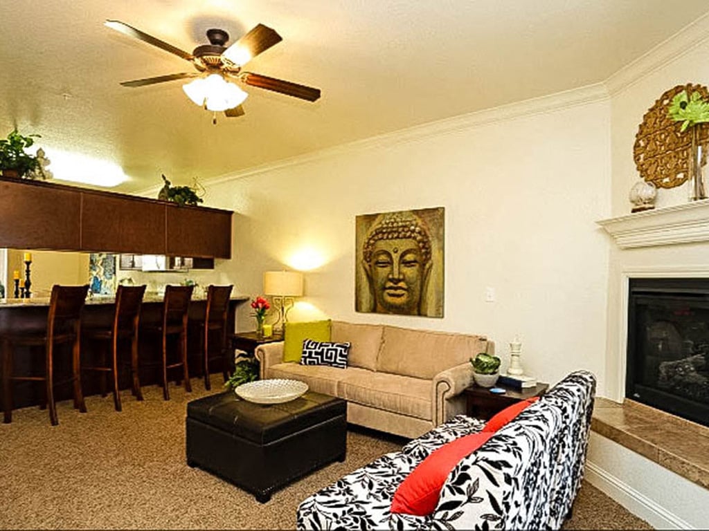 a living room with a couch and a ceiling fan