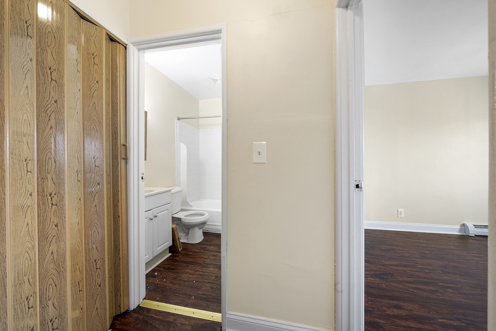 an open door leading to a bathroom with a toilet
