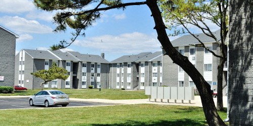 a car parked in front of an apartment building