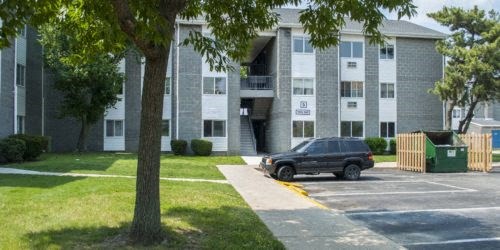 a car parked in front of an apartment building