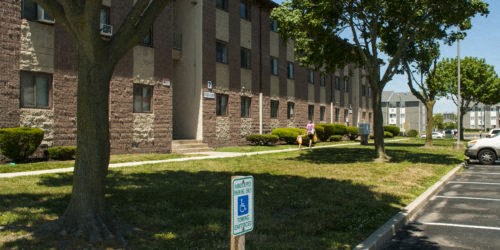 a person sitting on a bench in front of a building