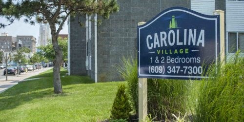 a sign village in front of a building