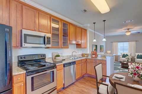 a kitchen with stainless steel appliances and wooden cabinets