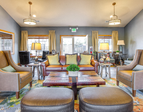 a living room with couches and chairs and a table