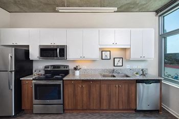 Kitchen With Modern Cabinetry at 10th and G Apartments in San Diego, California