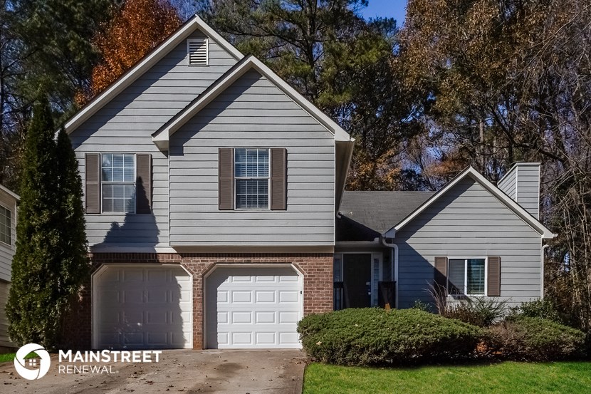 a home with a white garage door in front of it