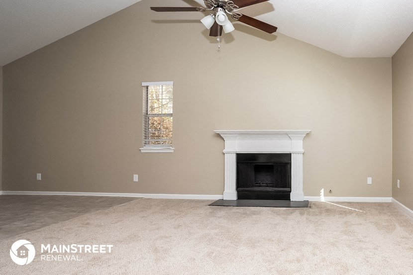 the master bedroom has a fireplace and a ceiling fan
